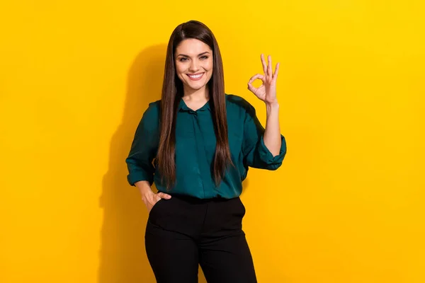 Photo of young pretty lady show fingers okey symbol approve good decision feedback isolated over yellow color background — Fotografia de Stock