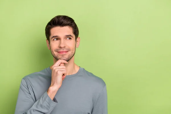 Photo of think millennial brunet guy look promo wear grey cloth isolated on green color background — Stok fotoğraf