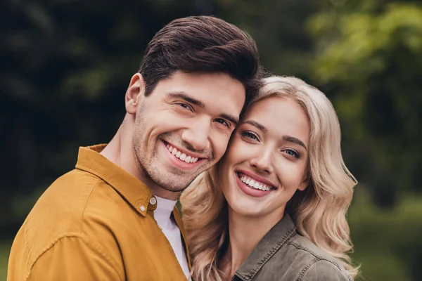 Portrait of attractive adorable careful cheerful amorous couple cuddling meeting on fresh air resting time outdoors — Stockfoto