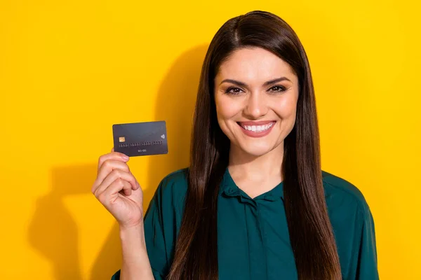 Photo of funny cute woman wear green shirt showing credit card smiling isolated yellow color background — Stock Photo, Image