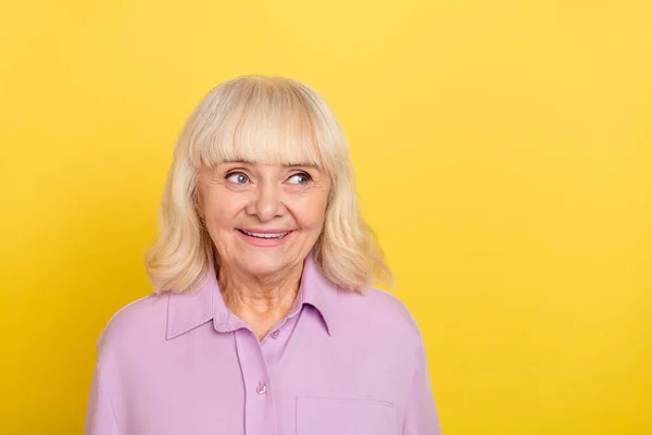 Portrait of attractive cheerful grey-haired granny thinking copy space isolated over bright yellow color background — ストック写真