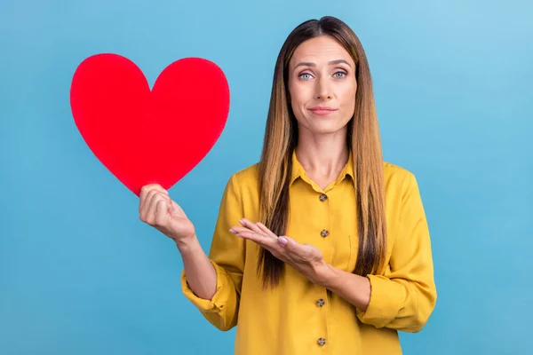 Photo of unsure mature brown hairdo lady index heart wear yellow shirt isolated on blue color background — Fotografia de Stock