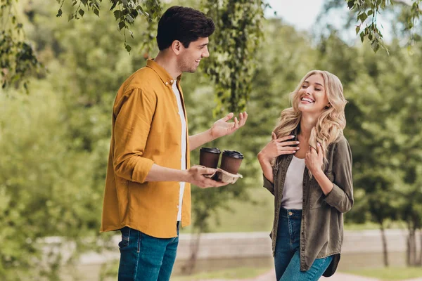 Portrait of beautiful handsome cheerful couple talking having fun meeting spending free time drinking latte outdoors — Fotografia de Stock