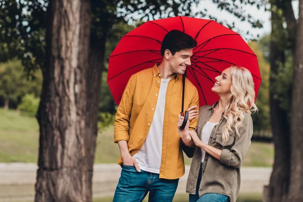 Portrait of attractive adorable amorous cheerful couple life partners meeting romance strolling using parasol outdoors — Stockfoto