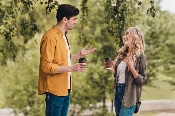 Portrait of beautiful handsome cheerful spouses talking having fun spending time weekend drinking latte outdoors — Fotografia de Stock