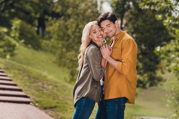 Profile side view portrait of beautiful handsome sweet adorable spouses cuddling enjoying weekend sunny day outdoors — Stockfoto