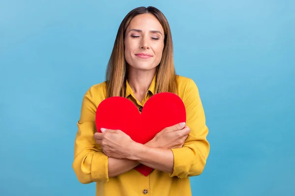 Photo of cute young brown hairdo lady hug heart wear trend cloth isolated on blue color background — ストック写真