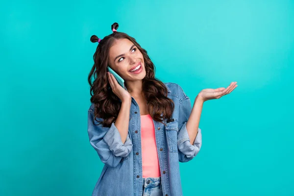 Photo of young lovely girl speak listen communication mobile look empty space isolated over turquoise color background — Foto Stock