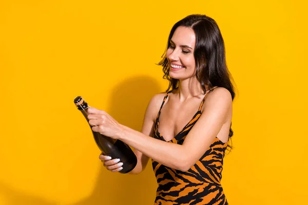 Profile side photo of young excited girl holiday open bottle champagne isolated over yellow color background — Photo