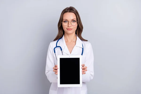 Photo of young lady pediatrician show tablet recommend therapist isolated over grey color background — Stok fotoğraf