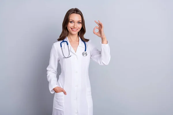 Photo of qualified lady paramedic suggest covid prevent vaccine show okay symbol isolated grey color background — Stock Fotó