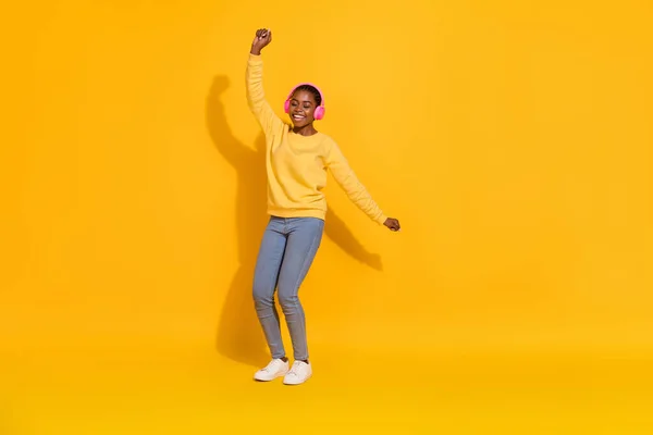 Full length body size view of attractive cheerful dreamy girl fan listening rock dancing isolated over bright yellow color background — 스톡 사진