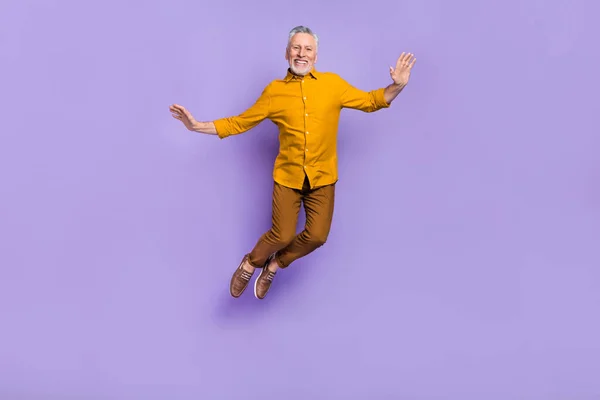 Helkroppsfoto av glada mogna mannen har kul hoppa upp fly dröm isolerad över lila färg bakgrund — Stockfoto