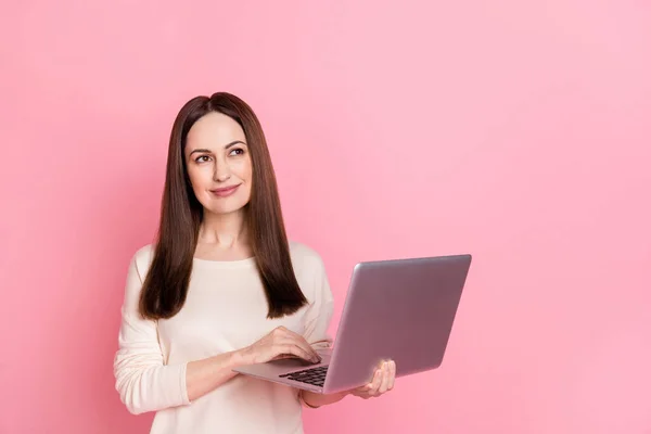 Photo of beautiful dreamy woman hold laptop home based business thoughtful creative job wear pullover isolated pink color background — стоковое фото