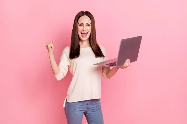 Photo of beautiful business woman raise fist got promotion project hold laptop home job wear pullover isolated pink color background — Zdjęcie stockowe