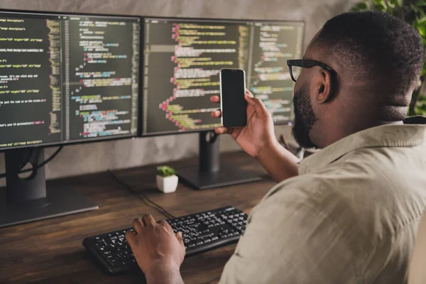 Profile side view portrait of handsome focused experienced guy geek using gadget developing project at workplace workstation indoors — Stockfoto