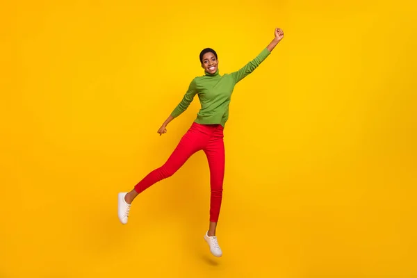 Photo of lucky sweet trans woman wear green turtleneck jumping high empty space isolated yellow color background —  Fotos de Stock