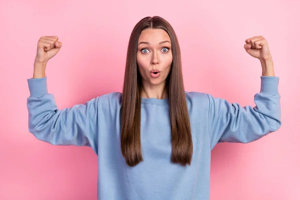 Portrait of attractive girly funky amazed cheerful girl demonstrating strong muscles isolated over pink pastel color background — Fotografia de Stock