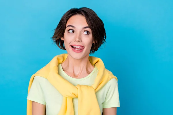 Photo of cute young brunette lady look promo wear yellow t-shirt isolated on blue color background —  Fotos de Stock