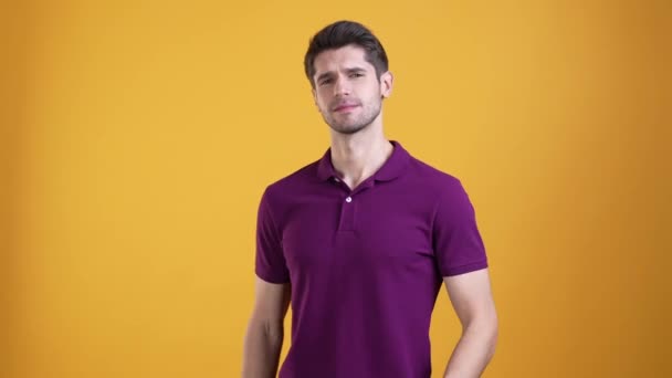 Cool guy showing his look outfit thumb up isolated bright color background — Video