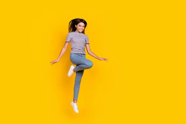 Full length photo of young lovely cheerful girl jumper dream travel isolated over yellow color background — Fotografia de Stock