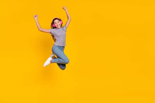 Full body photo of young excited girl have fun rejoice success fists hands melody sound isolated over yellow color background — Foto de Stock