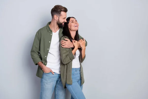 Portrait of attractive tender dreamy cheerful couple hugging laughing having fun isolated over grey pastel color background — Stock Photo, Image