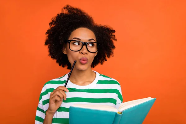 Portrait of attractive minded brainy intellectual wavy-haired girl creating plan list think isolated on bright orange color background — Stockfoto