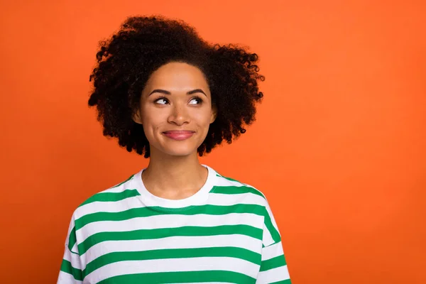 Portrait of attractive minded cheery smart girl overthinking copy blank space isolated over bright orange color background — Foto de Stock