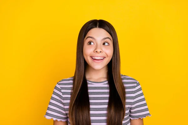 Photo of young cheerful lovely girl curious look empty space plan isolated over yellow color background — Stock Fotó