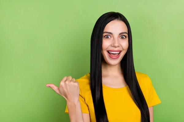 Photo of youth excited girl indicate finger empty space promo recommend suggest ads isolated over green color background — ストック写真