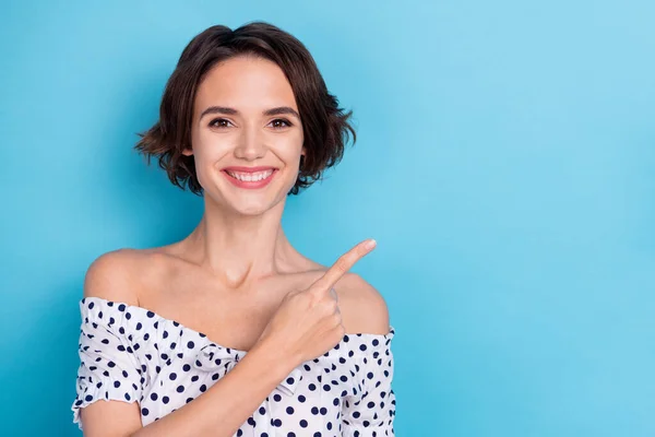 Portrait of cheerful pretty lady direct finger empty space offer promotion isolated on blue color background — Stok fotoğraf