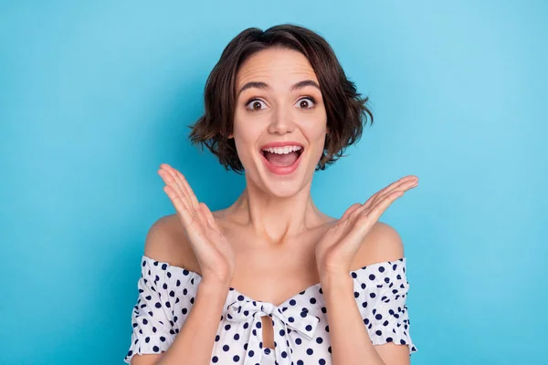 Photo of impressed cheerful girl raise hands open mouth cant believe news isolated on blue color background — Foto de Stock