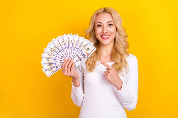 Photo of sweet funny woman wear white shirt pointing finger money fan isolated yellow color background — Stok fotoğraf