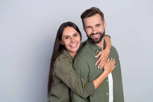 Portrait of attractive cheerful amorous couple best friends hugging romance spending time isolated over grey pastel color background —  Fotos de Stock