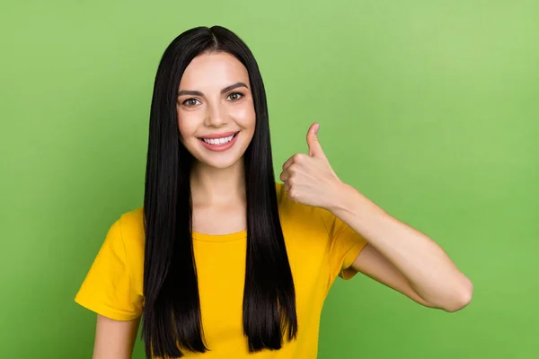 Photo of charming positive girl toothy smile show thumb up look camera isolated on green color background — Foto de Stock