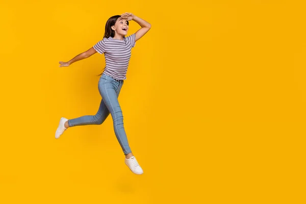 Full body profile side photo of young excited girl watch empty space go walk isolated over yellow color background — Stock Photo, Image
