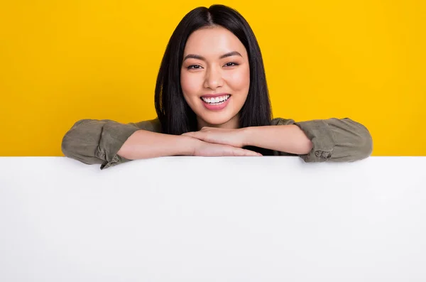 Photo of cute young brunette lady near big telephone wear khaki shirt isolated on yellow color background —  Fotos de Stock