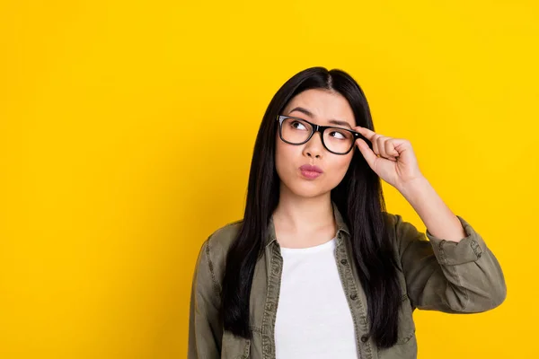 Photo of focused concentrated dreamy business girl look blank space thinking isolated on yellow color background — стоковое фото