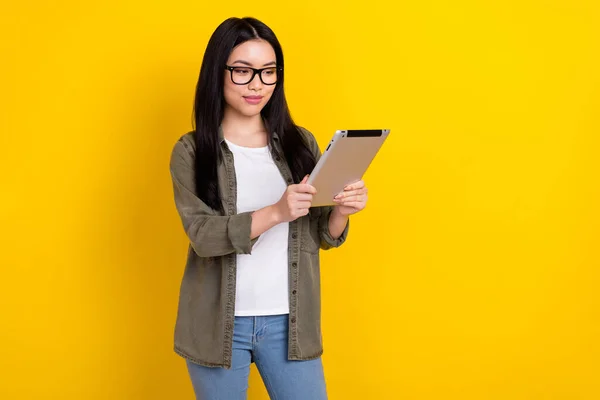 Photo of smart intelligent businesswoman reading important document use digital device isolated on yellow color background — 스톡 사진
