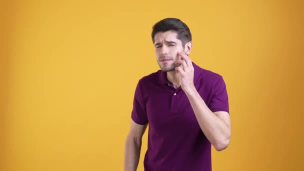 Upset guy look cheeks acne isolated bright color background — Stockvideo