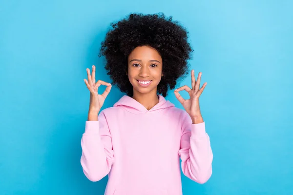 Portrait of attractive cheerful brunet bushy haired funky girl showing double ok-sign isolated over bright blue color background — 스톡 사진