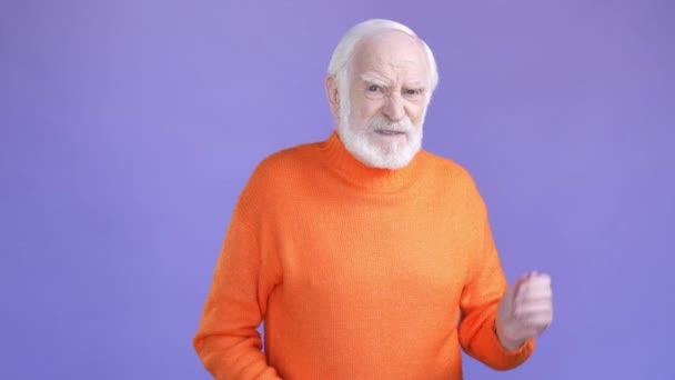 Displeased aged man not like awful smell isolated bright color background — Stock Video