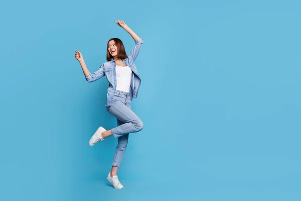 Photo of sweet shiny lady dressed denim shirt empty space dancing isolated blue color background — Stock Photo, Image