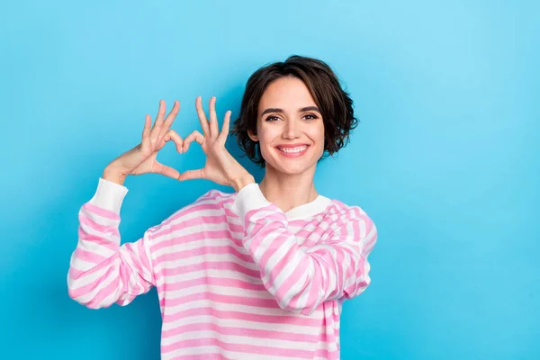 Photo of young good looking kind lady showing heart sign appreciate sincere feeling isolated on blue color background — ストック写真