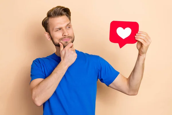 Photo of young guy hand touch chin look reaction icon button feedback idea isolated over beige color background —  Fotos de Stock