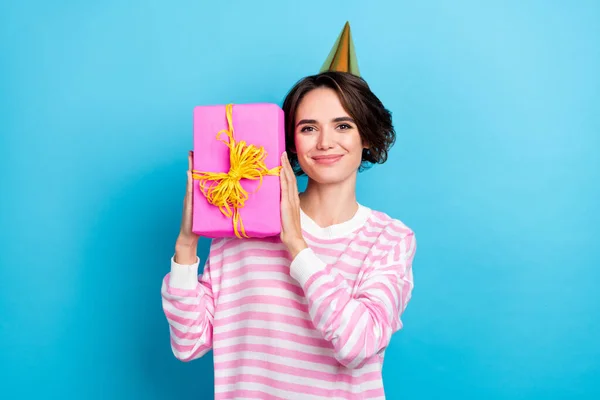 Portrait of cute pretty positive female hold demonstrate wrapped birthday giftbox isolated on blue color background — Stock fotografie