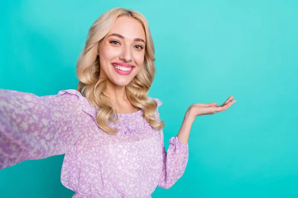 Photo of pretty charming lady wear violet blouse tacking selfie holding arm empty space isolated turquoise color background — Stok fotoğraf