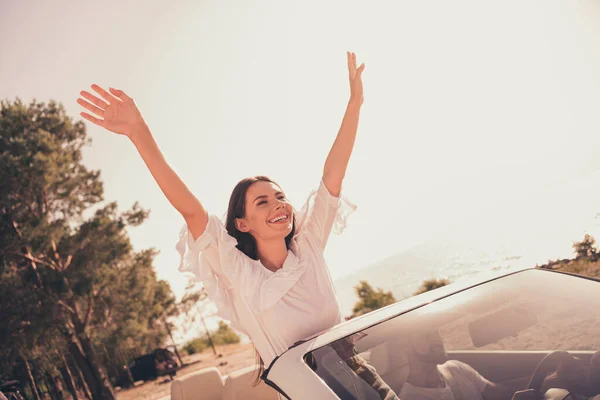 Photo of attractive excited young woman enjoy vacation hands up ride with husband auto honeymoon outdoors — Stok fotoğraf