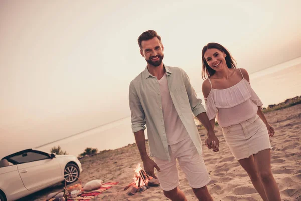 Photo of carefree funny young husband wife dressed casual outfits riding cabriolet walking enjoying sun outside nature countryside — Stock fotografie